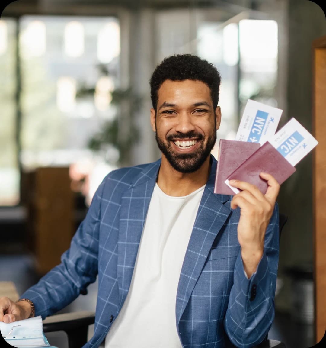 Man holding a US Visa and plane tickets